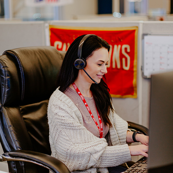 first residential empoyee talking on headset and working on computer